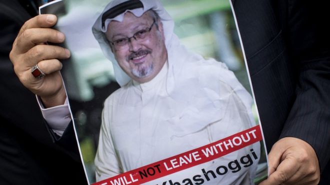 A man holds a poster of Saudi journalist Jamal Khashoggi during a protest in Istanbul,organised in front of the Saudi consulate.