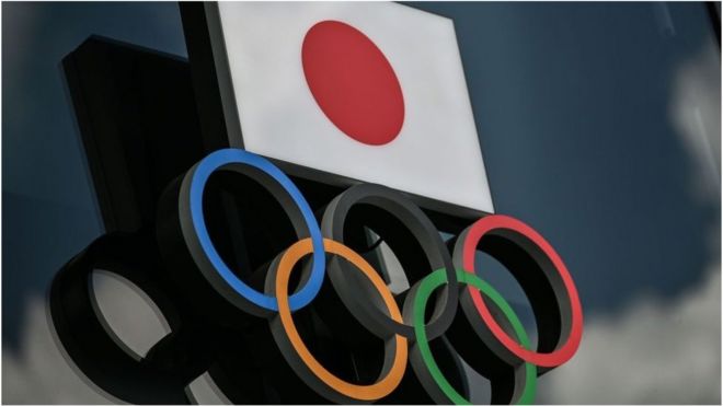 Olympic Rings and the Japanese flag are seen outside the Olympic Museum in Tokyo on August 24, 2020.