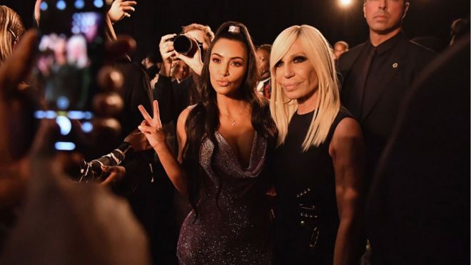 Kim Kardashian poses with Donatella Versace on a red carpet