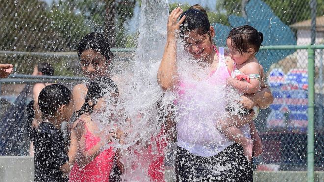 Children cooling off at a water park on a hot summer day in Alhambra, east of downtown Los Angeles, on 27 June