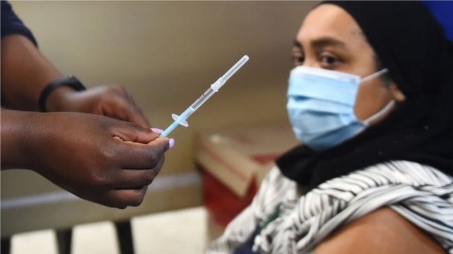 A woman receives the vaccine.