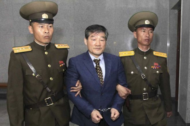 Ким Донгчул, в центре, гражданин США, задержанный в Северной Корее, сопровождается на судебное разбирательство в пятницу, 29 апреля 2016 года, в Пхеньяне, Северная Корея