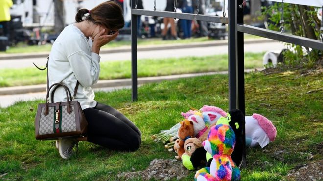 A woman cries at the makeshift memorial by the entrance of the Covenant School the day after a mass shooting in Nashville, Tennessee, U.S. March 28, 2023