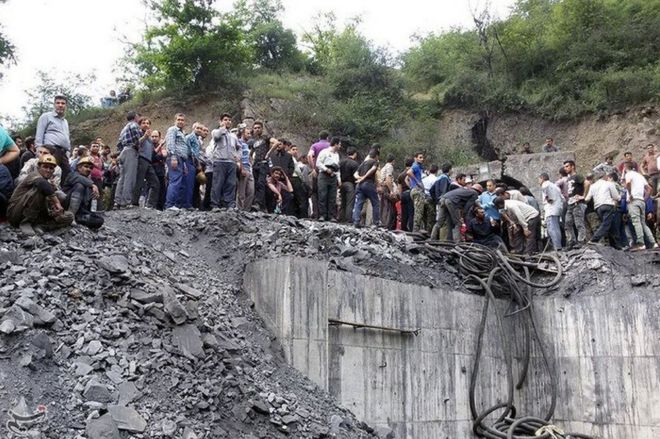 People gather at the site of an explosion in a coal mine in Golestan province, in northern Iran