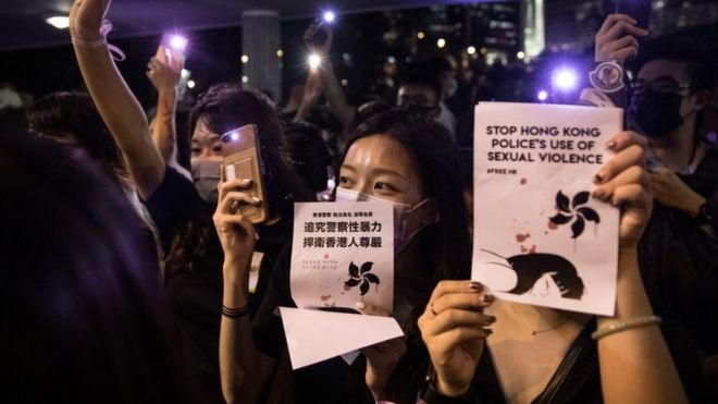 Protester holding up signs 'stop Hong Kong police's use of sexual violence'