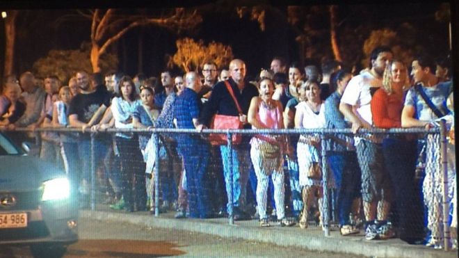 Поклонники стоят в очереди, чтобы вернуться домой после концерта Мадонны