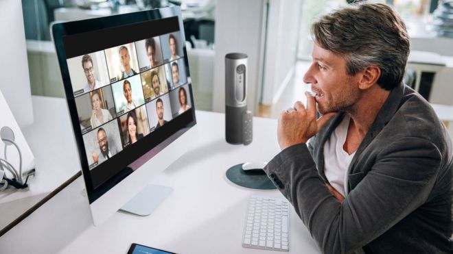 A man talks to 12 colleagues on Zoom's video conferencing app