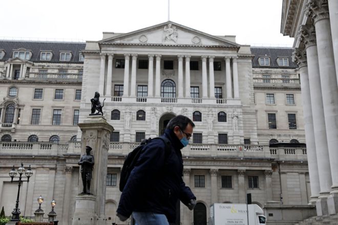 A man walks past the Bank of England in London