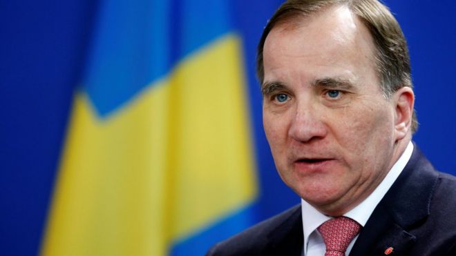 Stefan Lofven is photographed against a blue background