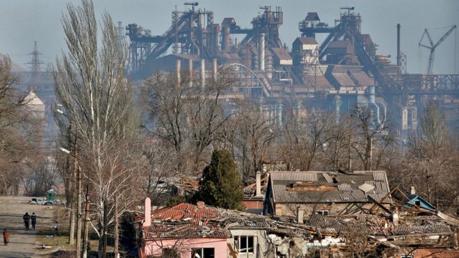 A view shows a plant of Azovstal Iron and Steel Works company behind buildings damaged in the besieged southern port city of Mariupol, Ukraine, on 28 March 2022