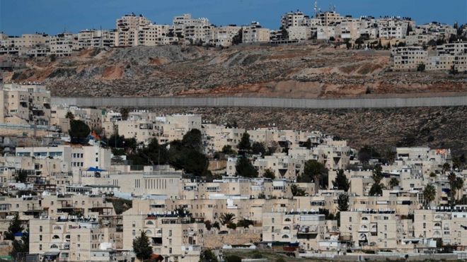 View of Israeli barrier separating the Jewish settlement of Neve Yaakov (foreground) and the Palestinian area of al-Ram in the occupied West Bank (27 January 2020)
