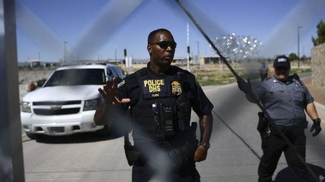 Security tell people to stop as they approach the border crossing fence at the Tornillo Port of Entry near El Paso, Texas