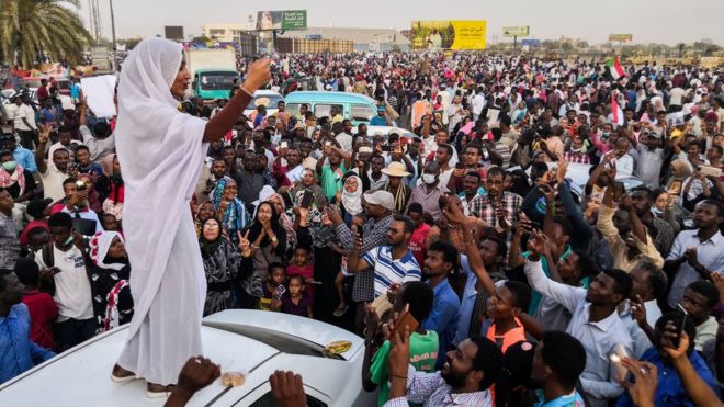 Muandamanaji maarufu , Alaa Salah, ambaye amepewa jina bandia "Nubian queen", akiongea na umati wa watu mjini Khartoum siku ya Jumatano