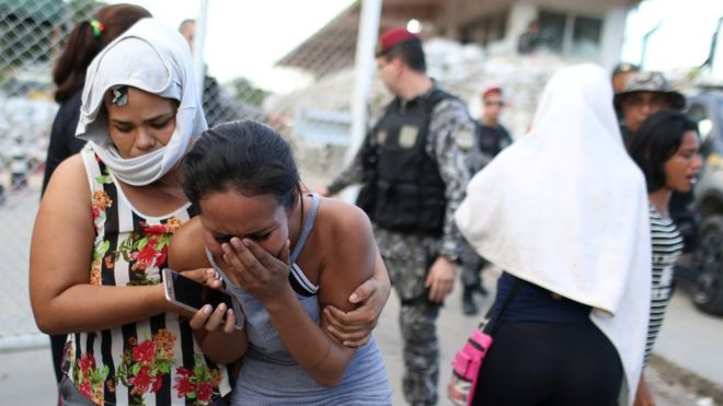 Relatives of inmates react in front of a prison complex in the Brazilian state of Amazonas