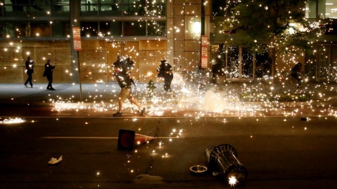People run as police disperse demonstrators during a protest amid nationwide unrest following the death in Minneapolis police custody of George Floyd, in Washington, 31 May 2020