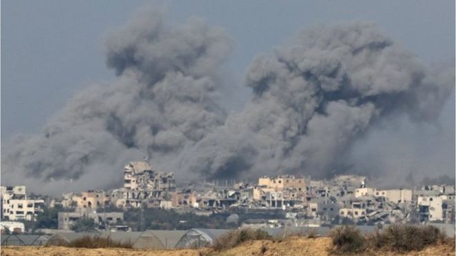 Smoke rises over destroyed buildings in Gaza, amid the ongoing conflict between Israel and the Palestinian Islamist group Hamas, as seen from southern Israel, December 6, 2023.