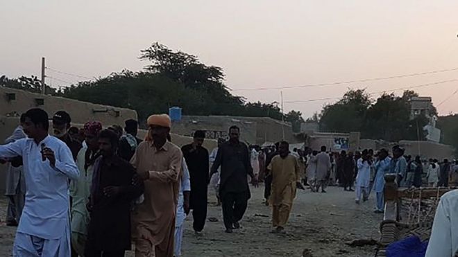 Pakistani devotees gather around the bodies of blast victims after a suicide bombing near a sufi shrine in Jhal Magsi October 5, 2017