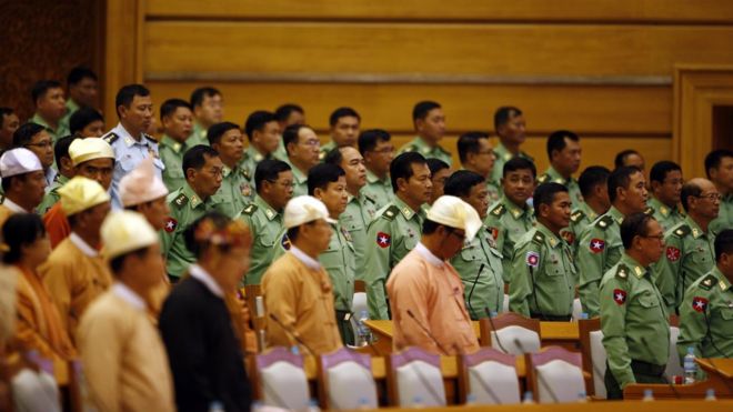 NLD and military representives stand for the arrival of Parliament Chairman Mann Win Khaing Than at the Union Parliament in Naypyitaw, Jan. 30, 2017.