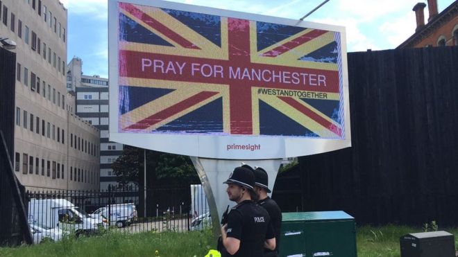 Billboard reading pray for Manchester