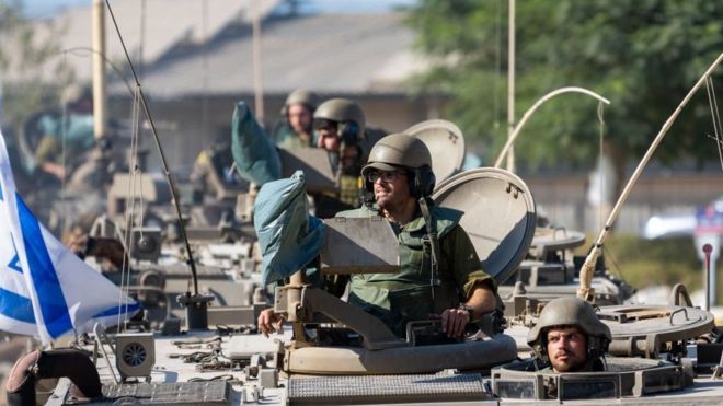 IDF Soldiers ride in armored personnel carriers