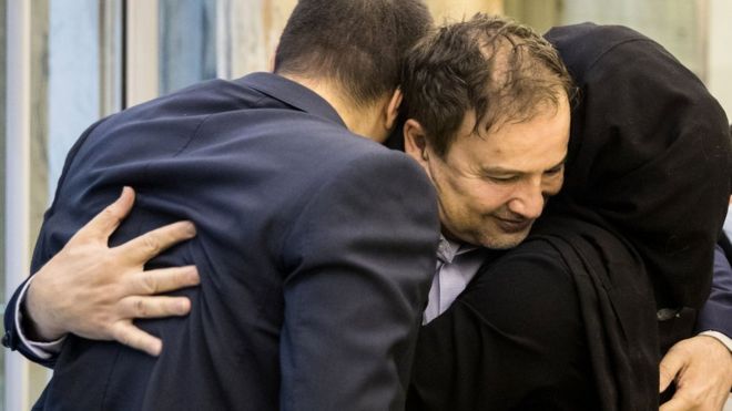 Iranian-American doctor Majid Taheri is hugged by family members on arrival at Tehran's airport on 8 June 2020