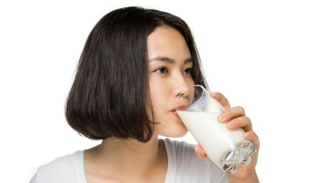 A young woman drinking milk