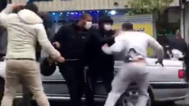 Screengrab of video appearing to show a man being detained during a protest in Tehran, Iran