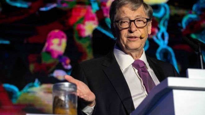 Bill Gates shows off a jar