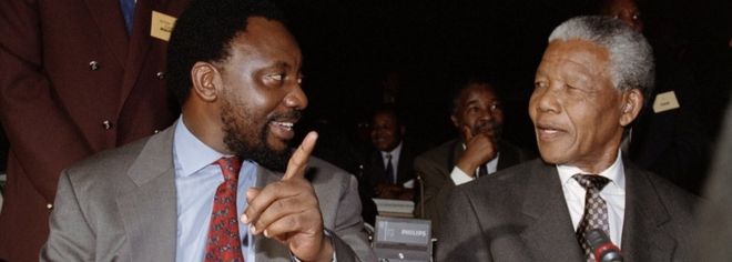 Генеральный секретарь АНК Сирил Рамафоса (слева) беседует с Нельсоном Манделой после прибытия во Всемирный торговый центр в Кемптон-Парке 18 ноября 1993 года, где политические лидеры официально одобрили конституционный проект, который положит конец 300-летнему правлению белого меньшинства.