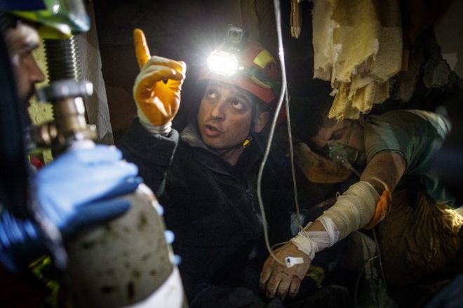 Firefighters extracted this injured man from the rubble in Thumane 