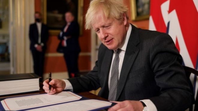 Boris Johnson signing the trade deal