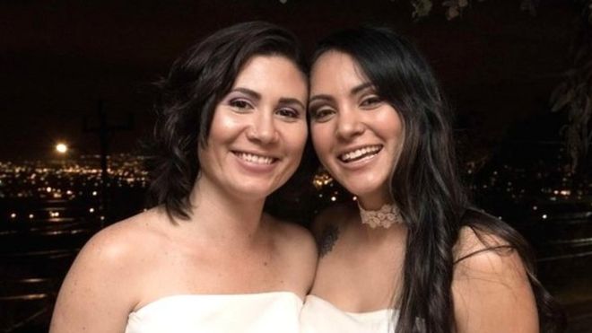 Newlyweds Alexandra Quiros (L) and Dunia Araya (R) pose during their wedding in Heredia, Costa Rica, on May 26, 2020