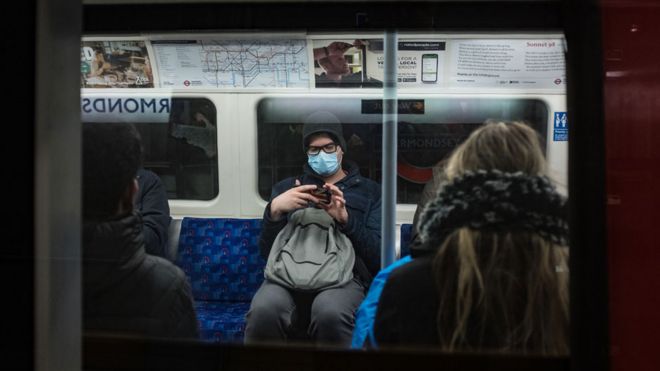 Man on the London Underground wearing a protective mask