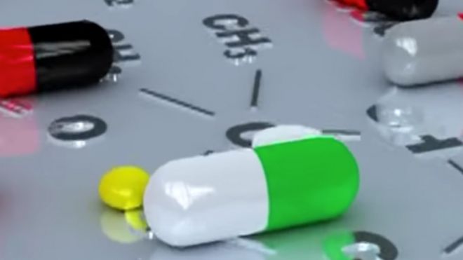 A video frame showing pills