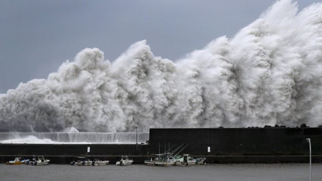 High waves breaking at a fishing port in Aki