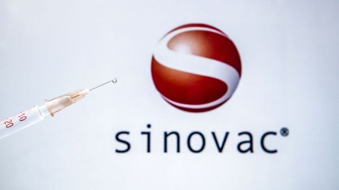 In this photo illustration taken in Ankara, Turkey on December 28, 2020 Sinovac Biotech COVID-19 vaccine logo is displayed on a screen with a syringe in the front.