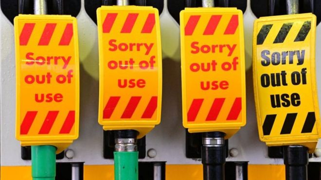 An "out of use" sign covers fuel pumps at a petrol station in Birkenhead, northwest England on September 27, 2021