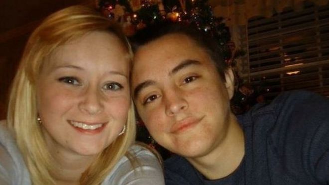 the young couple in front of a xmas tree