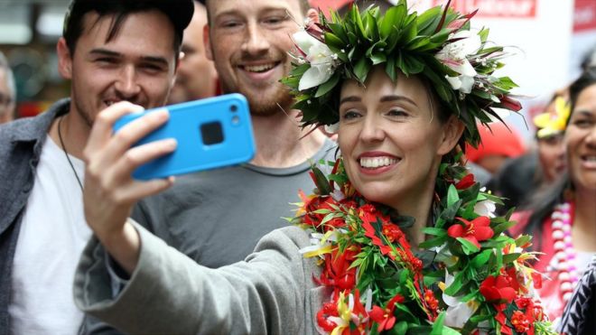 New Zealand"s Prime Minister Jacinda Ardern takes pictures with supporters during a campaign outing at Mangere Town Centre and market in Auckland, New Zealand, October 10, 2020.