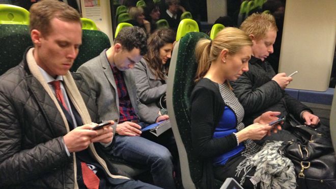 Commuters on mobiles