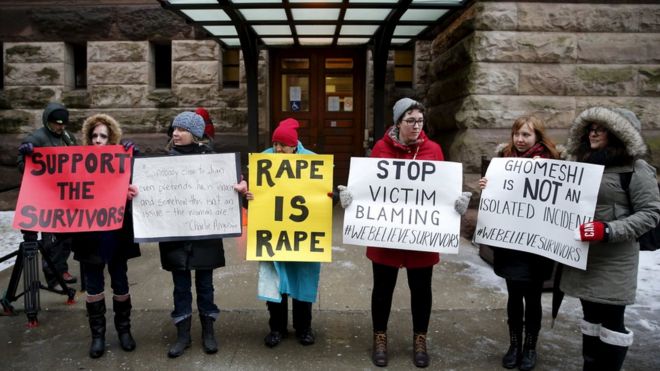 Протестующие стоят возле здания суда до того, как судья из Онтарио обнаружил бывшего канадского радиоведущего Цзян Гомеши невиновным по четырем обвинениям в сексуальном посягательстве и по одному подсчету удушья, в Торонто, 24 марта 2016 г.
