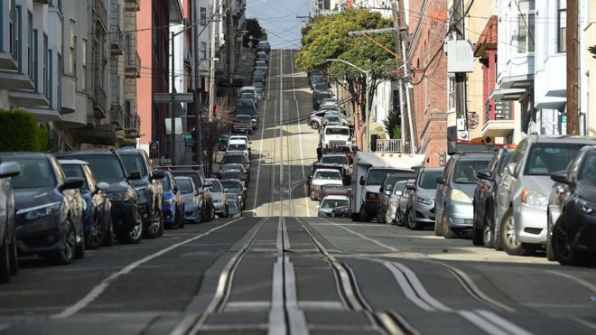 Washington Street, usually filled with iconic cable cars, is seen mostly empty in San Francisco