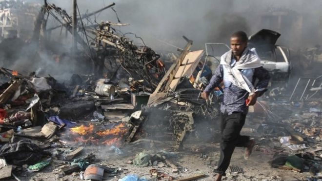 A man runs through the scene of a massive explosion in front of Safari Hotel in the capital Mogadishu, Somalia, 14 October 2017.