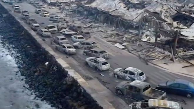 Burnt cars and buildings on sea front