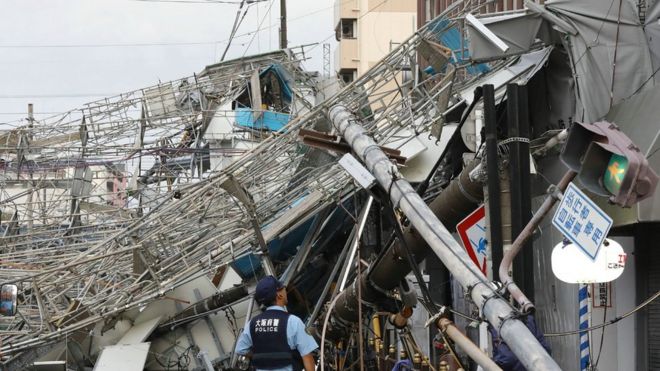 Damaged traffic boards and telecommunication relay poles are seen after they were brought down by strong winds caused by typhoon Jebi in Osaka on September 4, 2018.