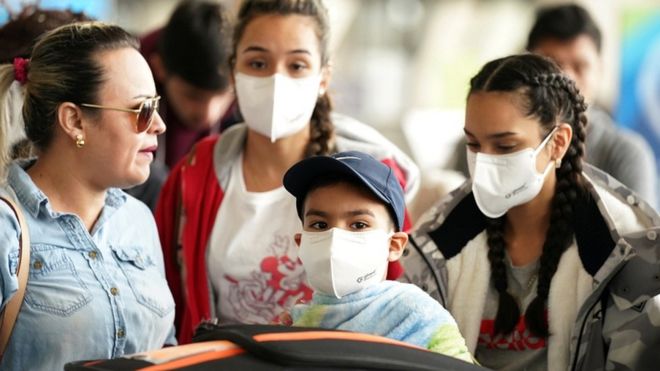 A family at Dulles International Airport a day after US President Donald Trump announced travel restrictions on flights from Europe to the US for 30 days to try to contain the coronavirus in Virginia, US, on 12 March 2020