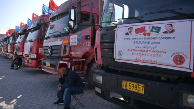 A Chinese worker sits near trucks carrying goods during the opening of a trade project in Gwadar port in 2016.