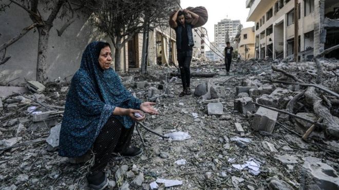 A Palestinian woman reacts as they inspect the rubble of a destroyed area at the Al-Ramal neighborhood, following Israeli air strikes, in Gaza City, 10 October 2023. More than 700 people have been killed and around 4,000 have been injured according to the Palestinian Ministry of Health, after Israel started bombing the Palestinian enclave in response to an attack carried out by the Islamist movement Hamas on 07 October. More than 3,000 people, including 1,500 militants from Hamas, have been killed and thousands injured in Gaza and Israel since 07 October, according to Israeli military sources and Palestinian officials.
