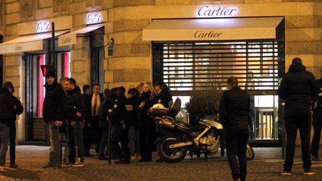 Police stand in front of a Cartier jewellery store on the Champs-Elysees avenue in Paris, after a robbery in November 2014