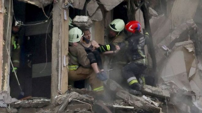 A woman being rescued from building hit by missile